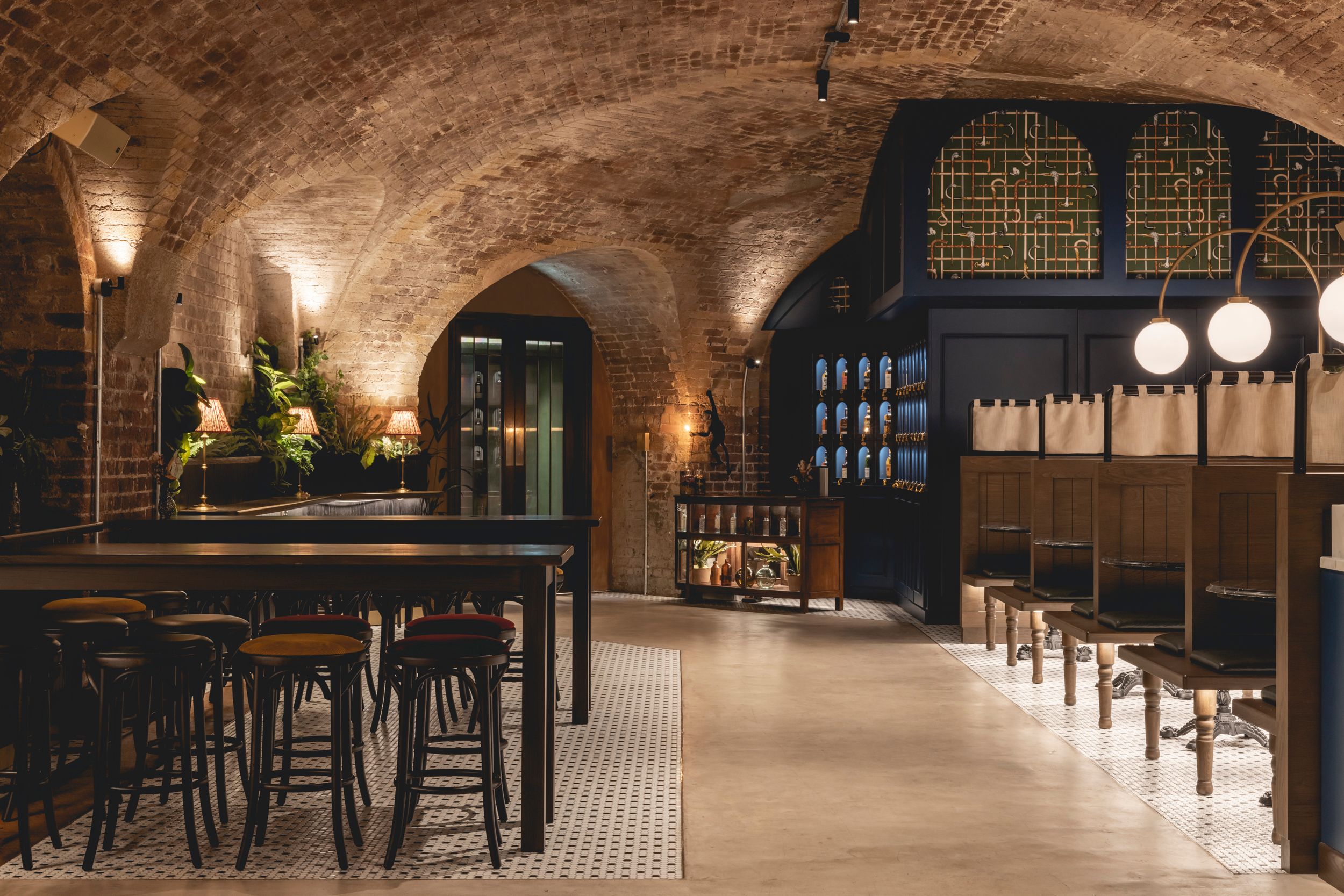 Booths for drinking and dining and high tables with stools for drinks in bar.